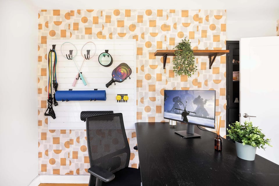 A work area,flanked by tennis rackets and succulents—where focus and fun collide.