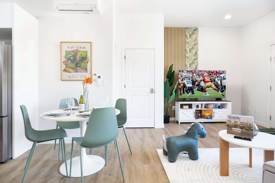 The dining area just steps away from sofa area, with 4 light green chairs around the table,you can enjoy the meal while watching a TV show!