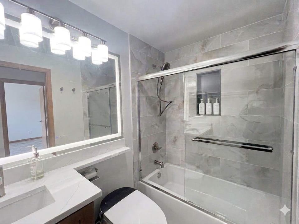 Enjoy a spa-like experience with a premium Delta rainfall shower, modern vanity, and thoughtfully upgraded finishes.