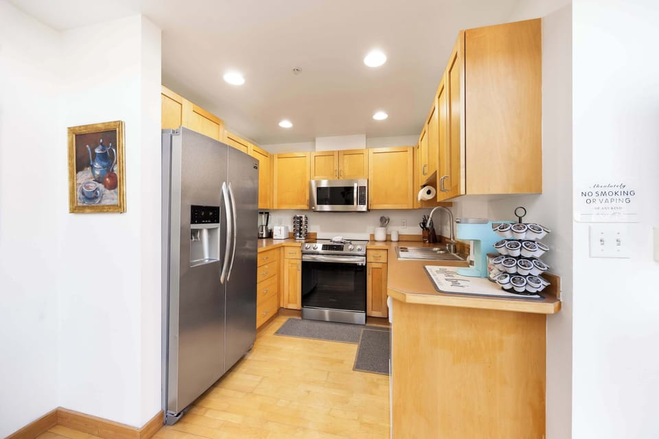 A compact kitchen done right: warm wood tones, smart storage, and gear that works as hard as you do.