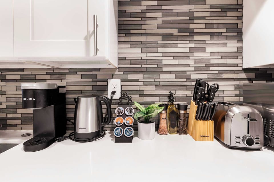 Sleek, fully equipped kitchen with Keruig Coffee station.Enjoy a cup of coffee for your morning.