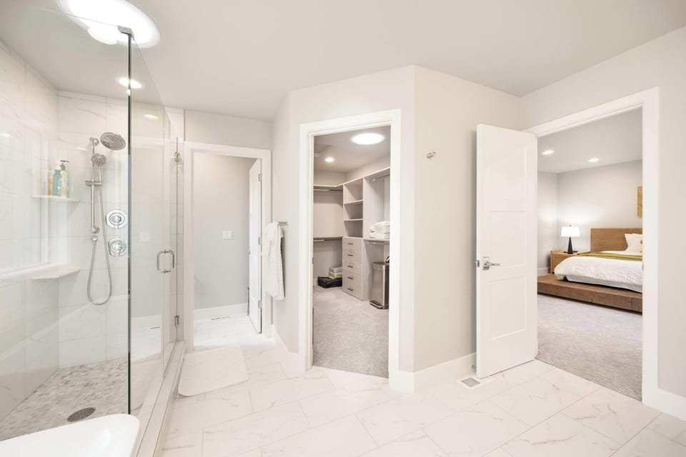 The bathroom and walk-in closet sit conveniently next to the bedroom, offering seamless functionality and elegant privacy.