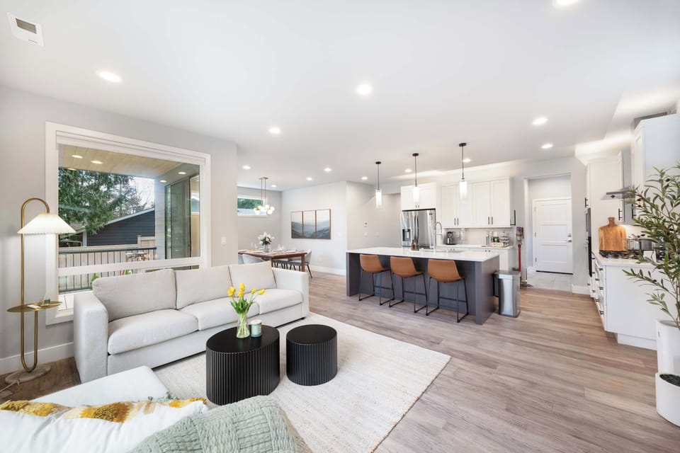 This open-concept living area seamlessly flows into the kitchen breakfast bar, creating a perfect space for entertaining and casual dining.