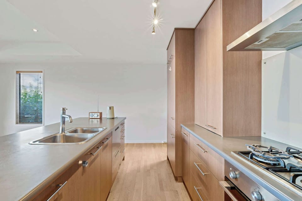 Fully equipped kitchen with gas hob and island bench.