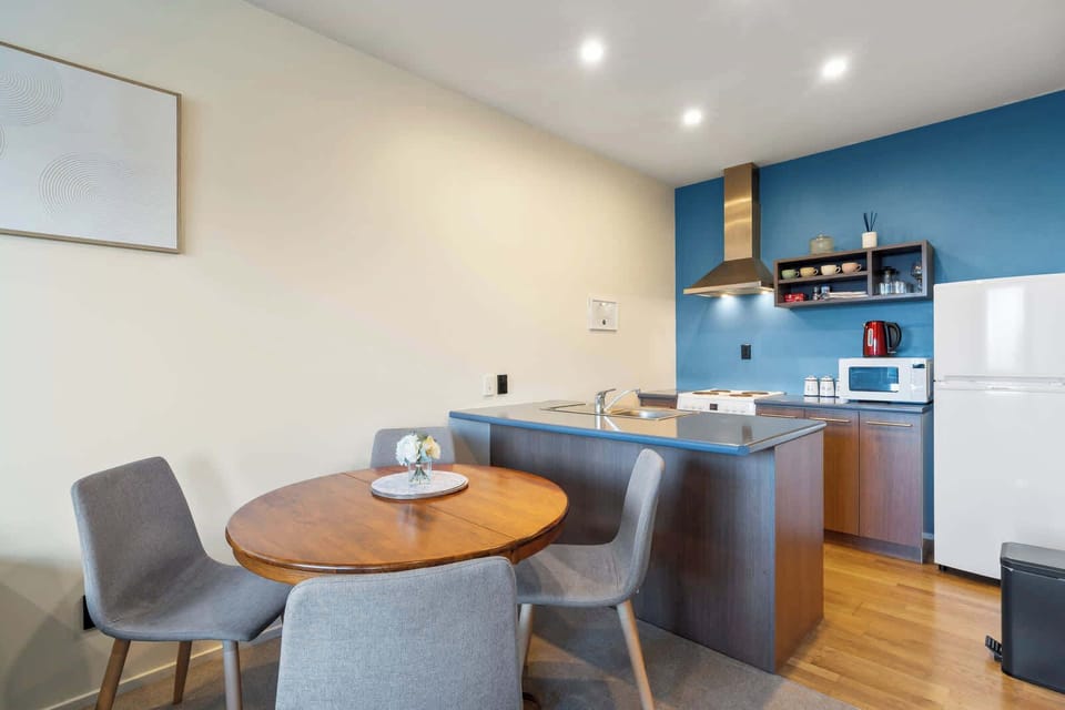 Enjoy intimate meals in this compact dining area, seamlessly connected to a functional kitchen space.