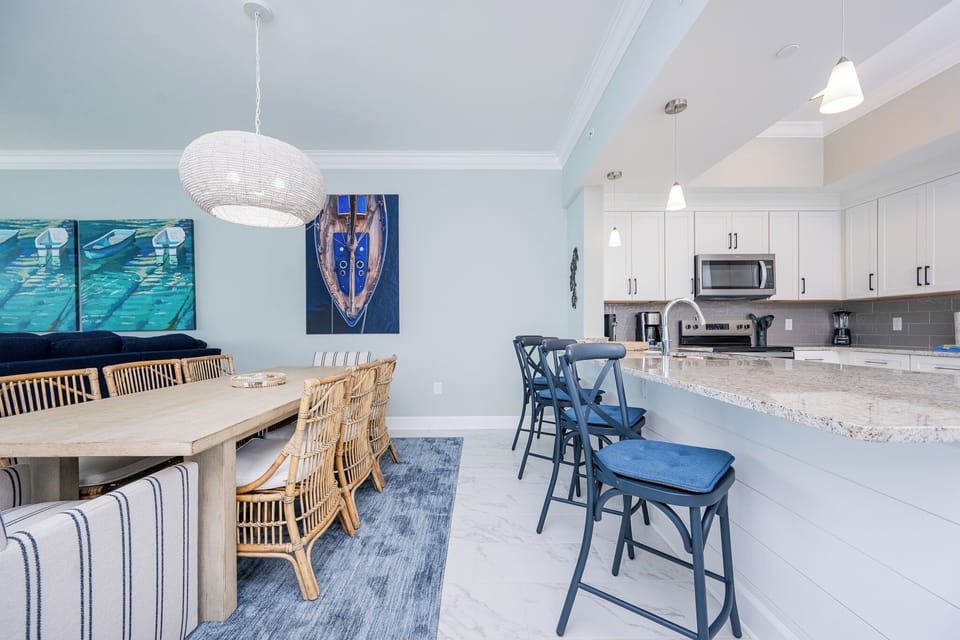 Gather around the spacious dining table or the breakfast bar, enjoying a relaxed atmosphere with coastal decor