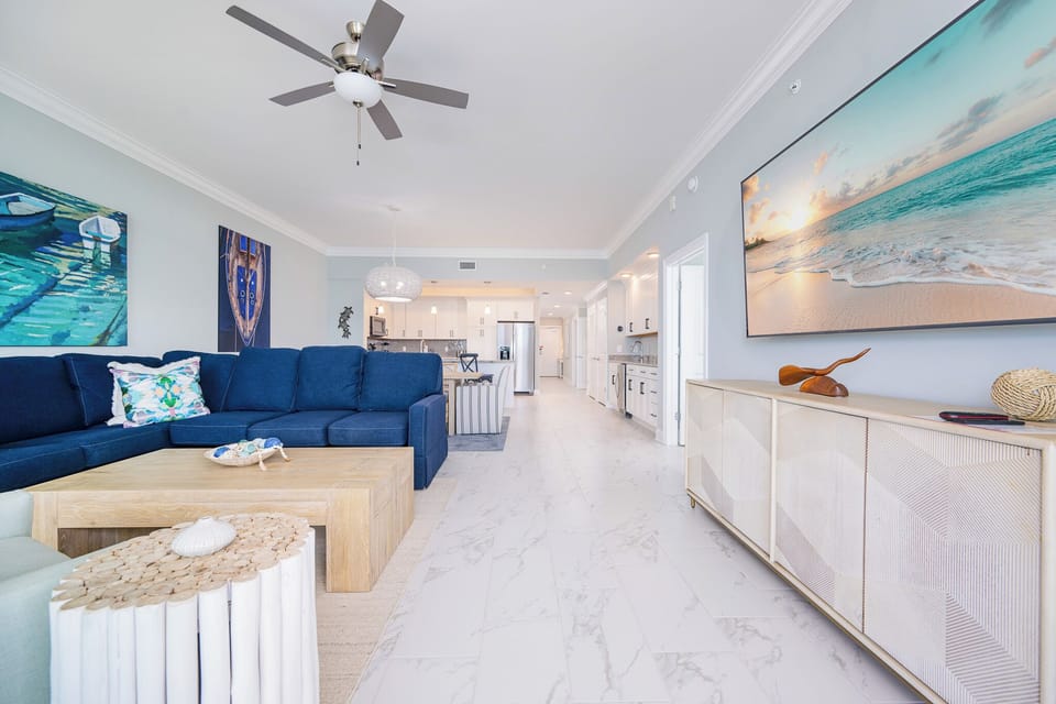 Relax on the spacious sectional sofa, surrounded by coastal decor and a large TV for your entertainment