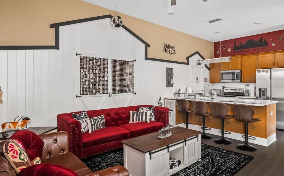 Step into Nashville charm with this bold, music-themed space! Enjoy plush seating, a full kitchen, and fun barn-style decor—complete with a disco ball. Ideal for relaxing or entertaining in Music City style!
