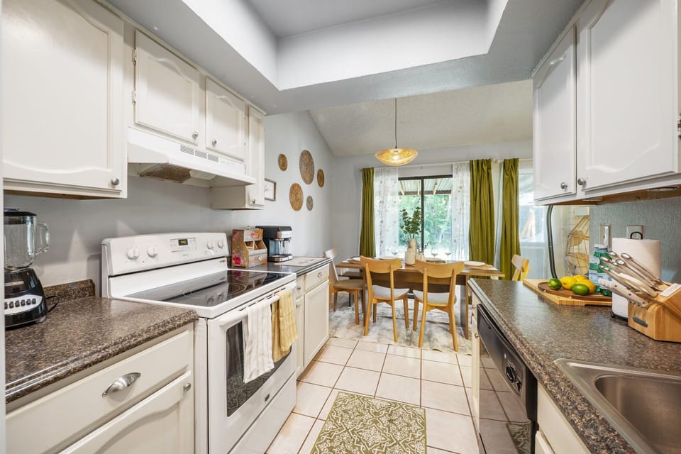 Fully functional kitchen. Stove, oven, fridge, coffee machine, and blender.