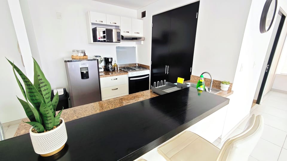 The kitchen is fully equipped with modern appliances and utensils, ensuring you have everything you need for cooking and preparing meals during your stay.