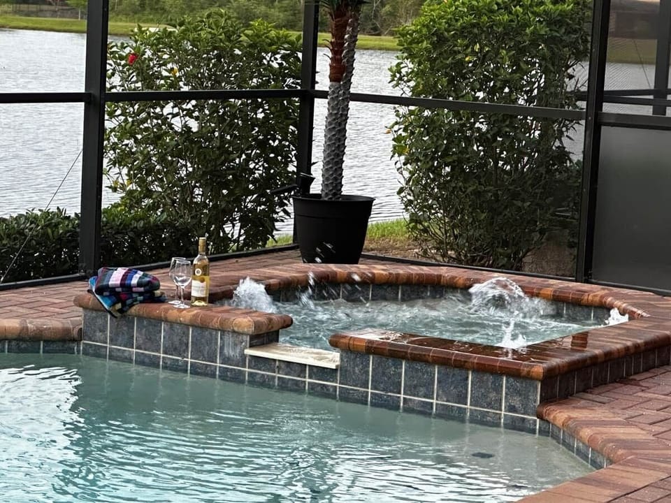 Private spa bubbling under the screen enclosure for ultimate relaxation