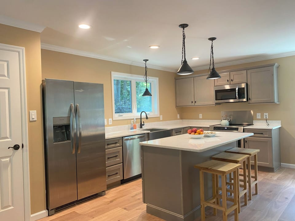 Kitchen with stainless steel appliances and quartz countertops.