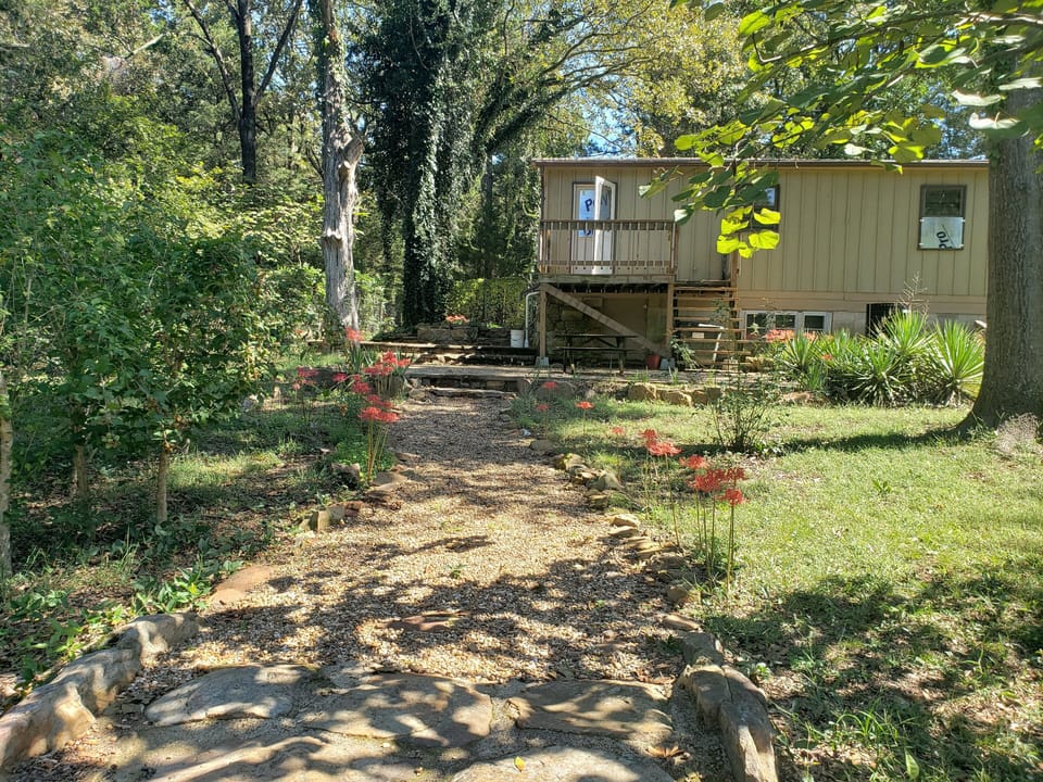 Back view. Wood deck, patio chairs, BBQ grill, table and chairs.
