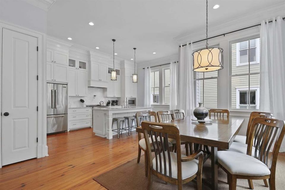 The open layout keeps conversations flowing from the kitchen to the dining table, making every meal a shared experience