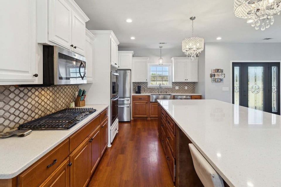 Cook like a pro in the full-service gourmet kitchen—double ovens (with air fryer!), gas range, pantry, and all the essentials you need.