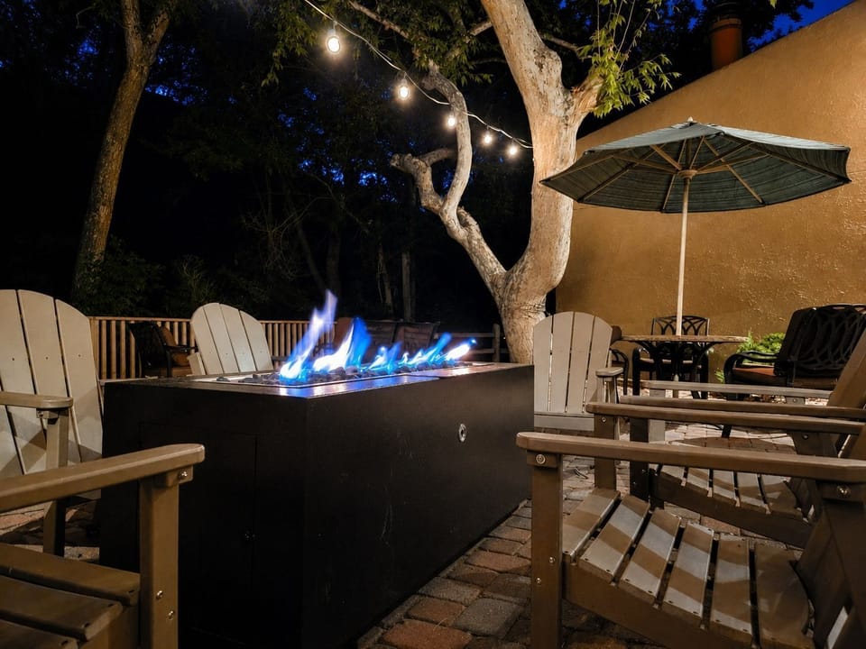 A fire pit glows warmly, creating an inviting ambiance for evening gatherings outdoors.