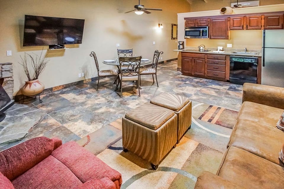 An inviting interior featuring a cozy living space and partial kitchen, ideal for relaxation and family gatherings after a day of exploring Sedona.