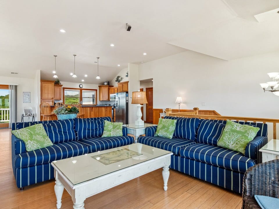 The open-concept Living Area with surround sound is perfect for movie nights or relaxing after a beach day.