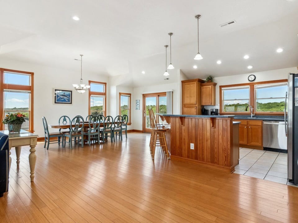 The Dining Area and Kitchen with a breakfast bar and built-in desk create a welcoming space for sharing meals and making memories.