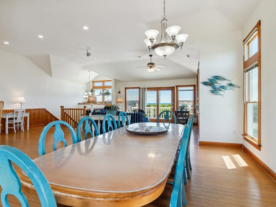 The Dining Area and Kitchen with a breakfast bar and built-in desk create a welcoming space for sharing meals and making memories.