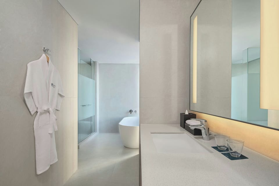 Suite, 1 King Bed (Savvy Suite) | Bathroom | Free toiletries, hair dryer, slippers, bidet