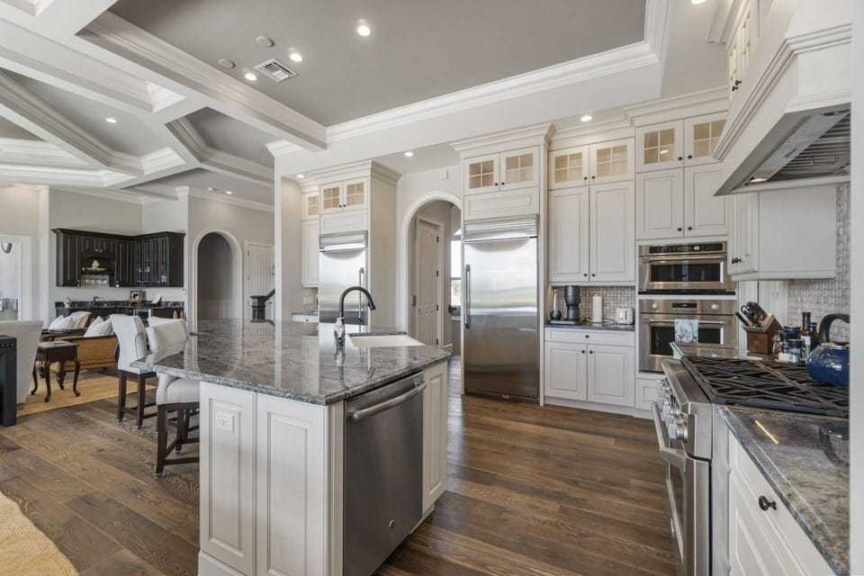 The kitchen features high end stainless appliances and upgraded granite.