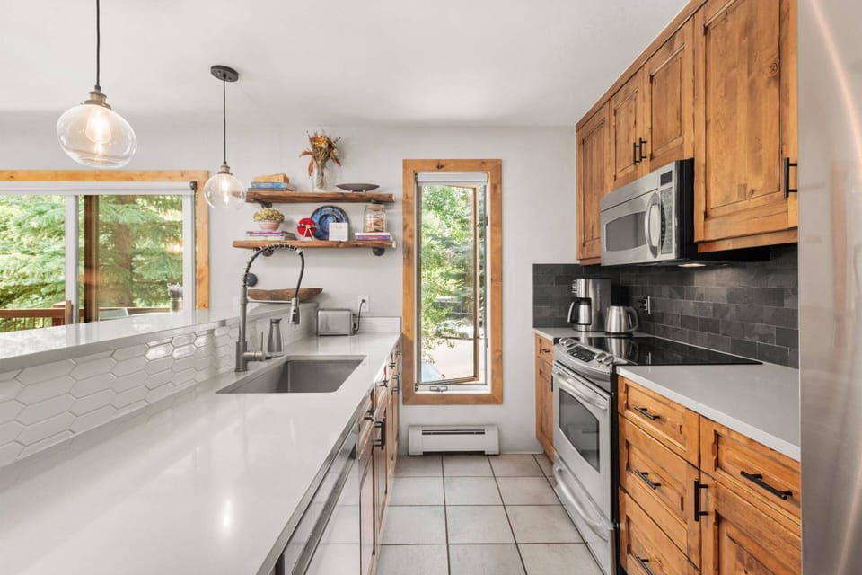 The updated kitchen is bright, modern and fully stocked with everything you need to prepare meals.