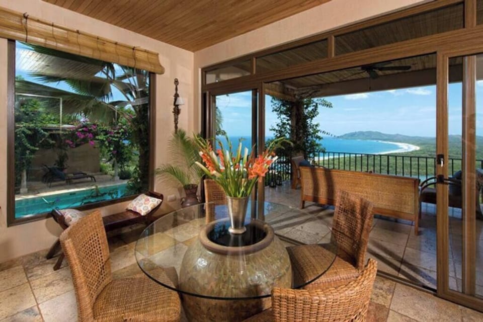 Elegant indoor table with luxury design, perfect for shared meals or family games during your Tamarindo vacation stay.