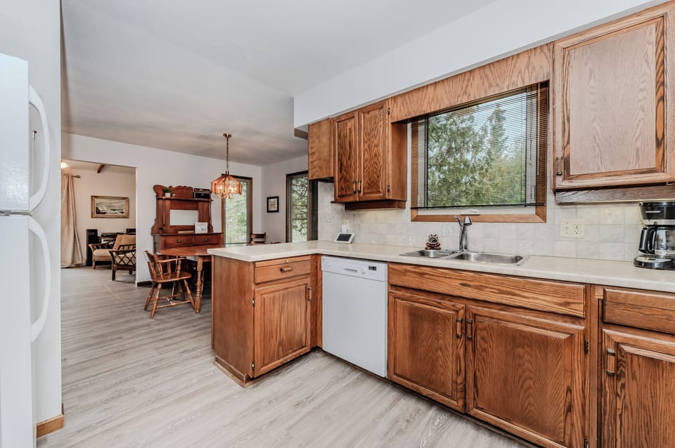 Prepare and share meals in a spacious kitchen and dining area overlooking nature—perfect for relaxing evenings at your vacation rental.