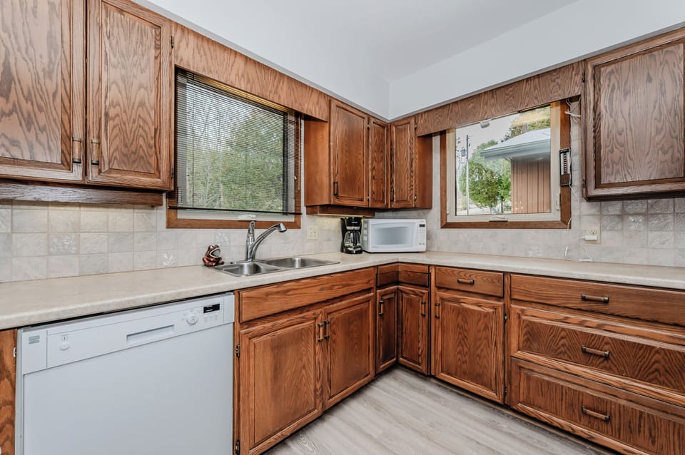 Enjoy a fully equipped, classic cottage kitchen with wood cabinetry, ideal for cooking memorable meals during your lakeside escape.