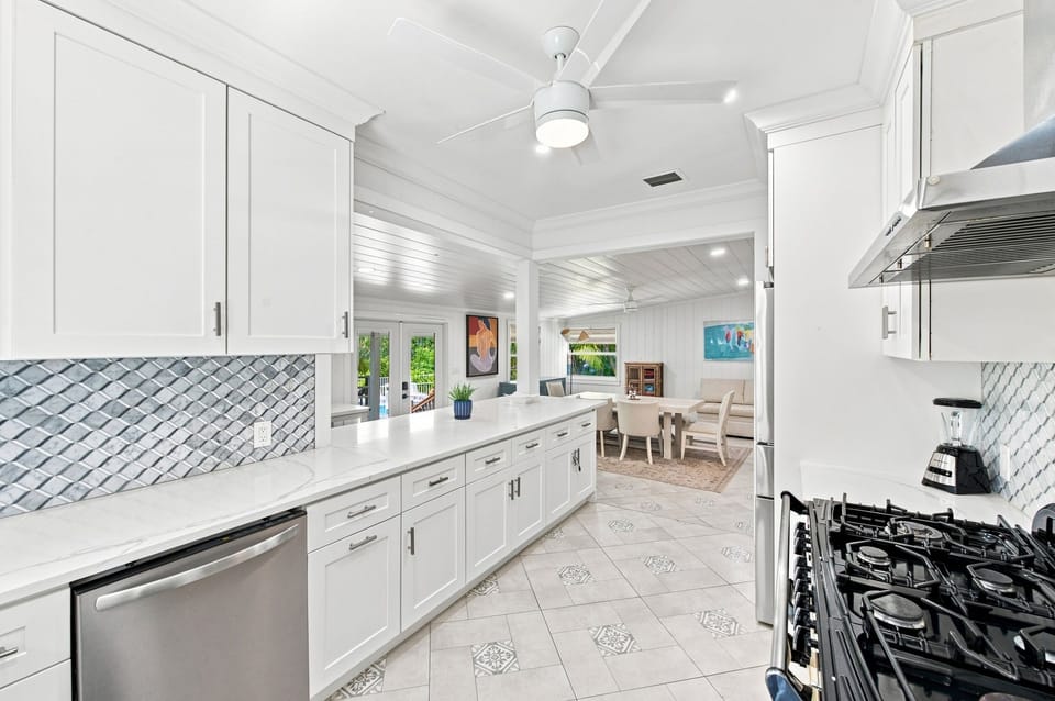 Kitchen view with subway tile backsplash and dining area beyond