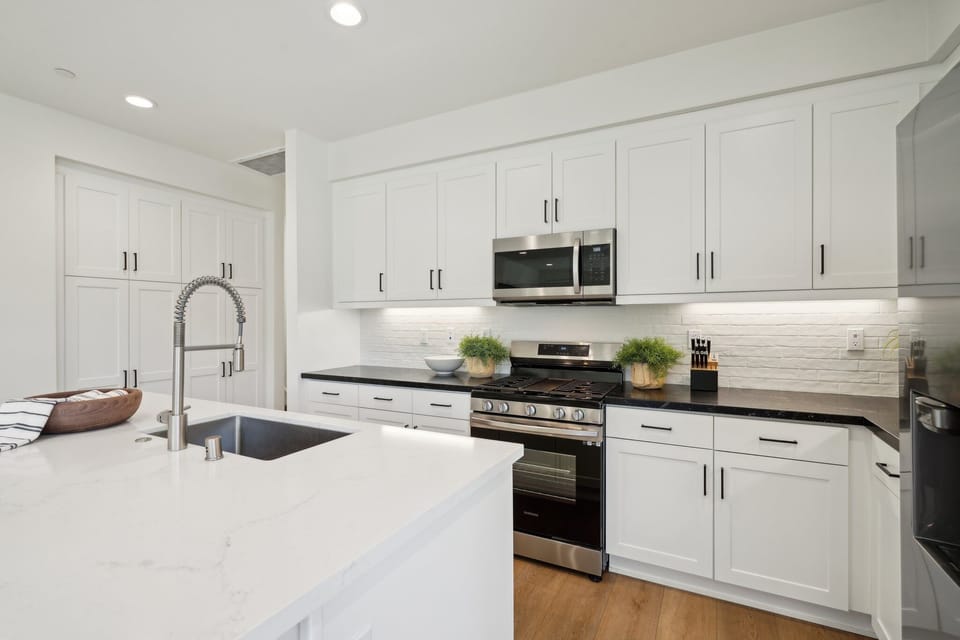 Bright kitchen with island workspace and modern fixtures makes cooking for your group easy and enjoyable every day.