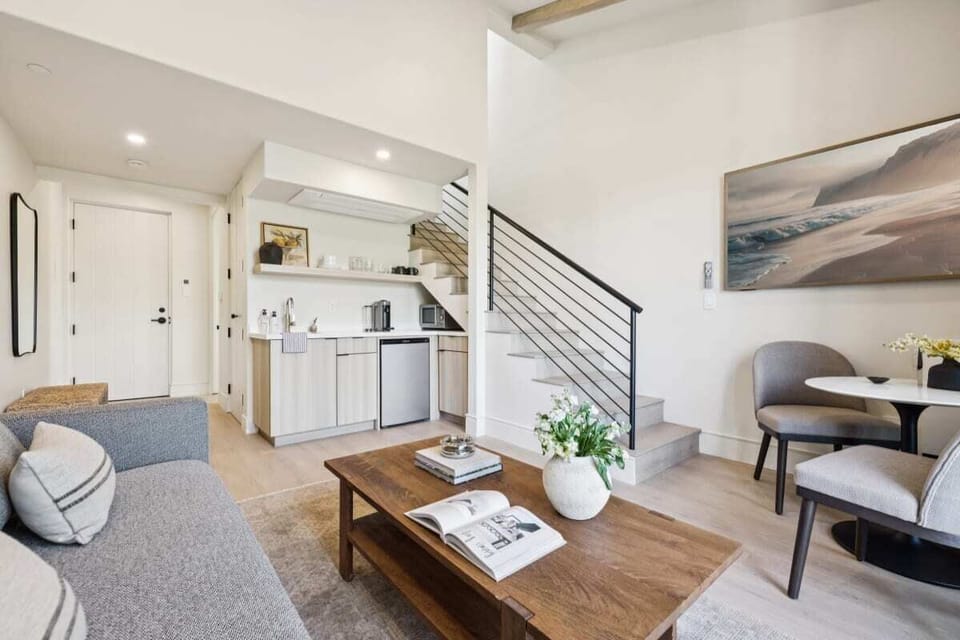 Living area with sleeper sofa, kitchenette, and lounge chairs