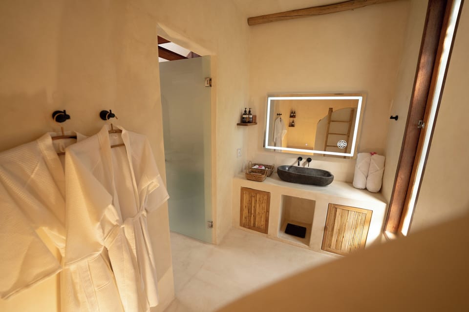 King Suite with Hot Tub + Unlimited Coffee | Bathroom | Eco-friendly toiletries, hair dryer, bathrobes, slippers