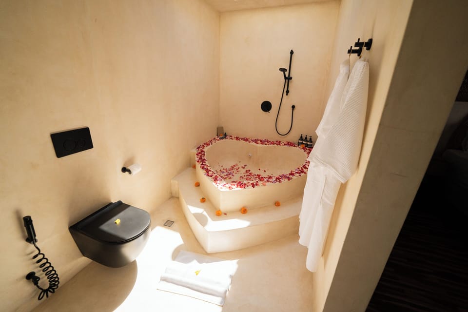 King Suite with Hot Tub + Unlimited Coffee | Bathroom | Eco-friendly toiletries, hair dryer, bathrobes, slippers