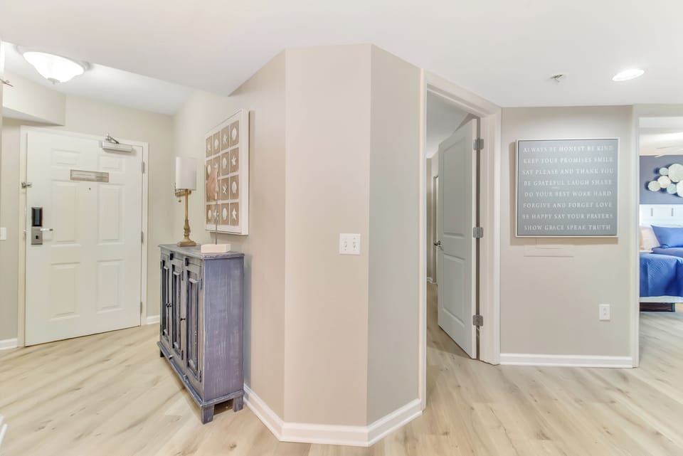 Step into your bright, welcoming entry where warm wood floors and thoughtful touches create the perfect homebase for your getaway.
