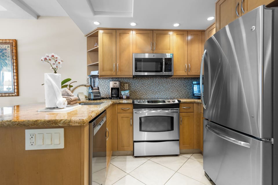 Your fully equipped kitchen features stainless steel appliances, warm wood cabinetry, and granite countertops—perfect for preparing fresh meals during your stay.