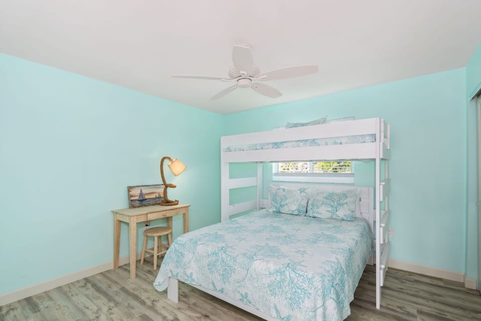 Smart and stylish space with a twin-over-queen bunk bed and a desk for added convenience.
