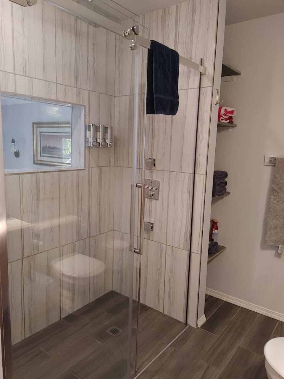 King Cove shower with shampoo, conditioner, & body was dispenser. Also a window into the sleeping area