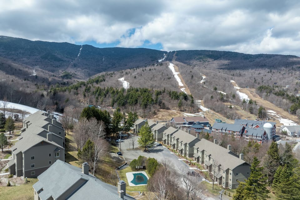 - Scenic view of mountains and ski slopes near property   - Outdoor pool and community area nestled in the valley   - Perfect location for ski getaways and summer retreats