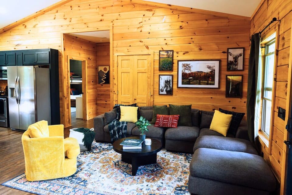 Step into an inviting living room designed for comfort and connection. Featuring a 75” TV, an electric fireplace, and décor inspired by the surrounding forest, it’s the perfect space to relax, gather, and enjoy mountain moments together.
