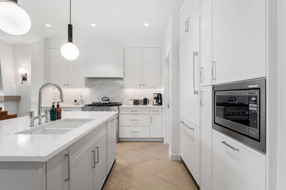 Full kitchen with a large island, coffee makers (drip & french press), and an air fryer.