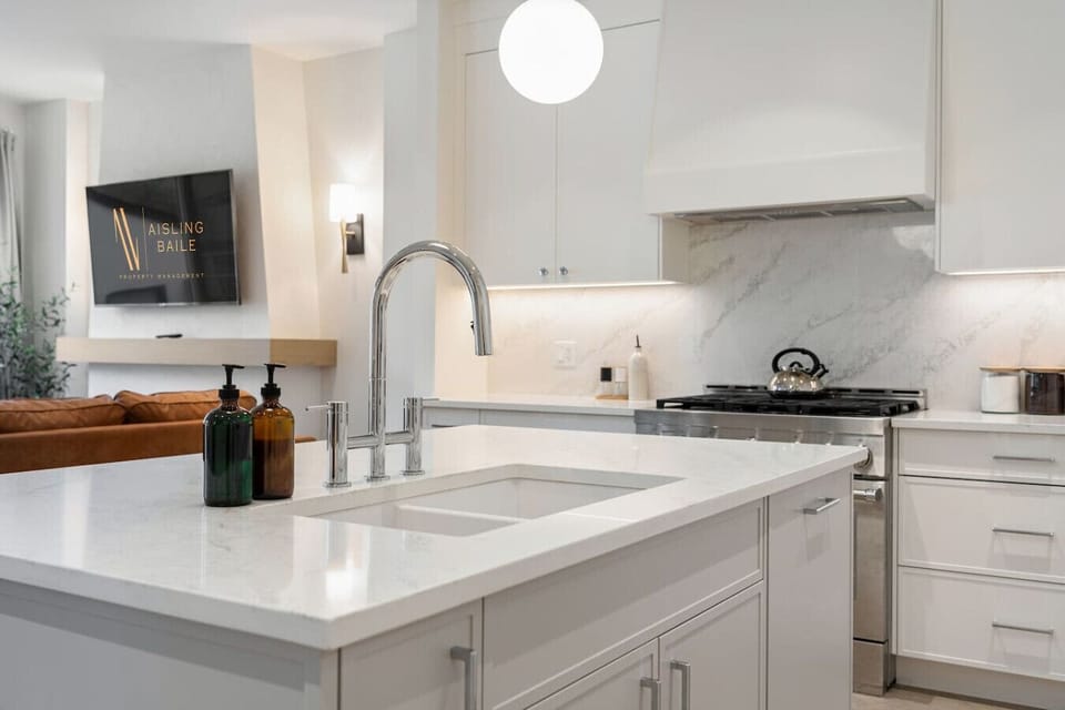 Full kitchen with a large island, coffee makers (drip & french press), and an air fryer.
