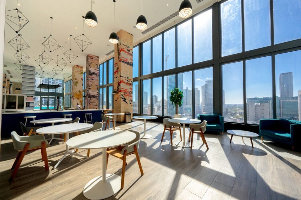 Enjoy our stylish communal workspace or lounge with comfortable seating and stunning urban views
