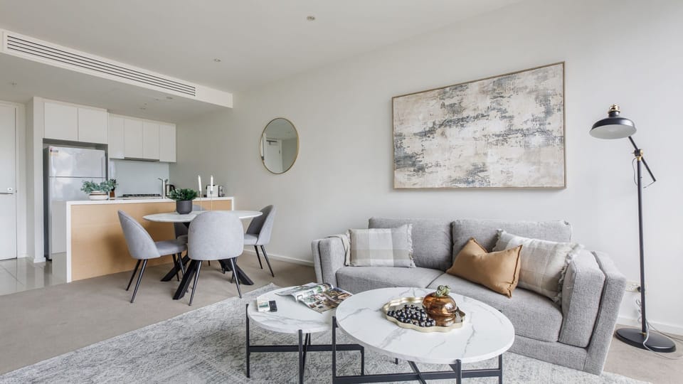 Elegant open-plan lounge with curated decor and sophisticated finishes.