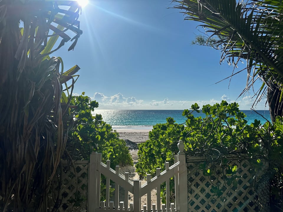 Down our private path and through the gate lies an empty pink sand beach