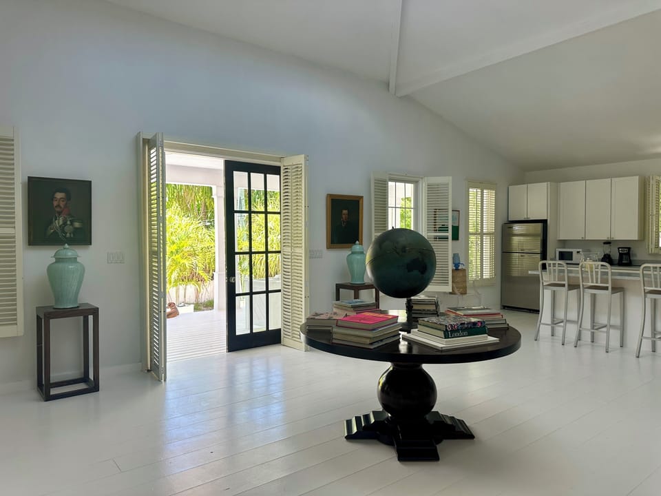 The veranda overlooks a hushed sandy lane, leading lazily to the sea.