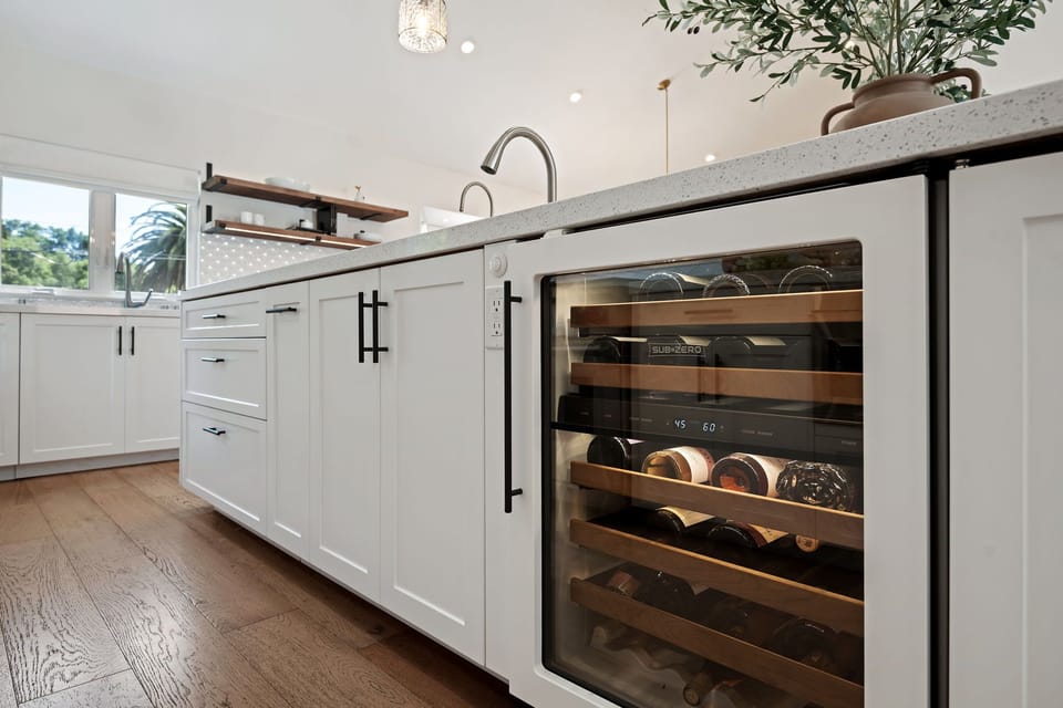 Kitchen features luxury appliances including an ice machine and wine fridge
