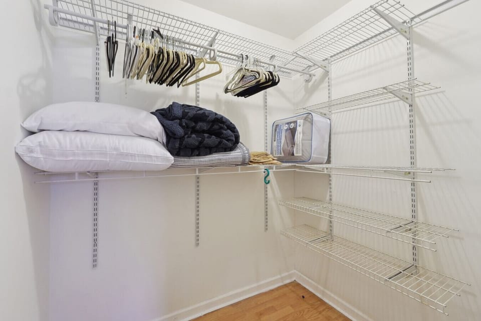 Closet stocked with fresh linens, pillows, and hangers for your convenience.