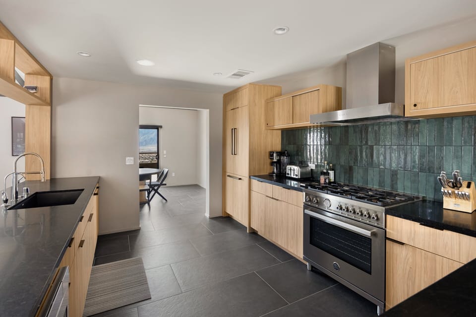 Sleek cooking space with statement tile backsplash.
